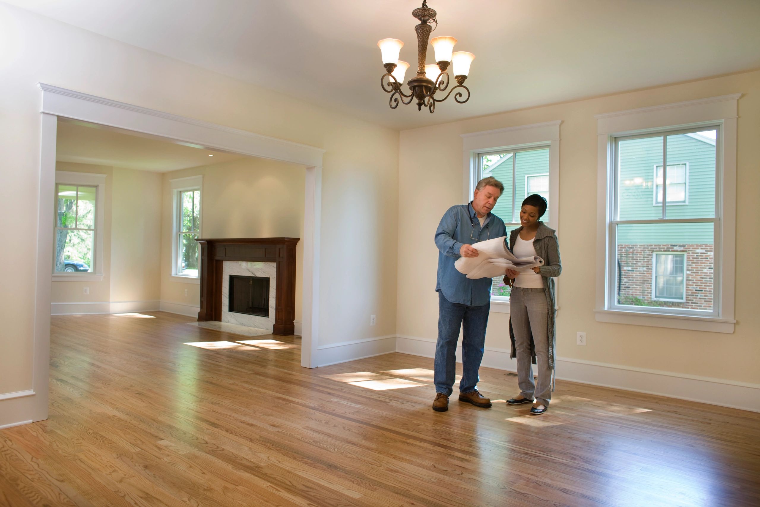 Contractor reviewing blueprints with homeowner